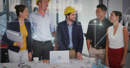 Discussing design plans five professionals gathering around conference room table, with blueprints....
