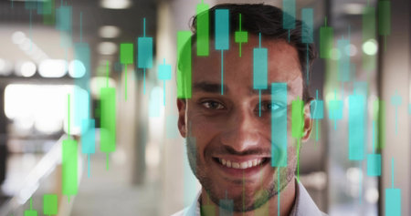 Smiling man wearing white shirt standing office corridor, with candlestick chart overlay. Business,...