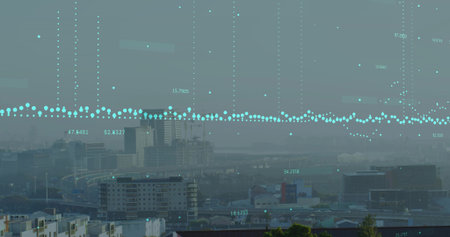 Displaying turquoise data points hovering over apartment blocks and office towers at elevated view....