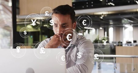 Financial analyst analyzing data on laptop in open-plan office, with floating currency icons....