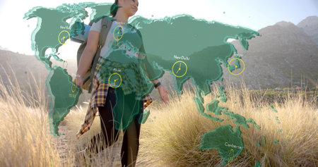 Walking Asian hiker in grass carrying backpack on trail. Adventure, exploration, outdoor, travel,...