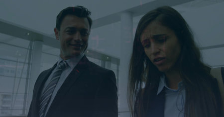 Sharing worried looks coworkers wearing suit in airport lobby with shoulder bag and gate. Professional, office, corporate, modern, architecture, teamwork, hierarchyの写真素材