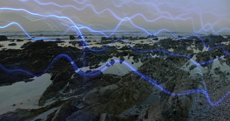 Coastal shoreline showing jagged outcrops and tide pools at low tide, with blue waveform overlay....