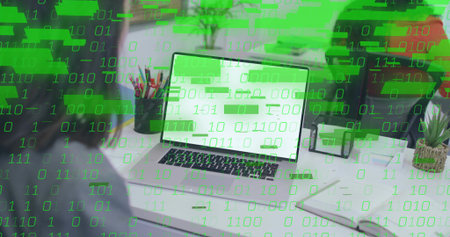 Entering code on silver laptop computer at home office workspace, with green binary overlay. Technology, programming, digital, workspace, innovation, productivity, modernの写真素材