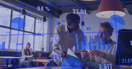 Collaborating African American man and coworker examining laptop in office, with data overlay. Business, teamwork, technology, data, analytics, modern, professionalの写真素材