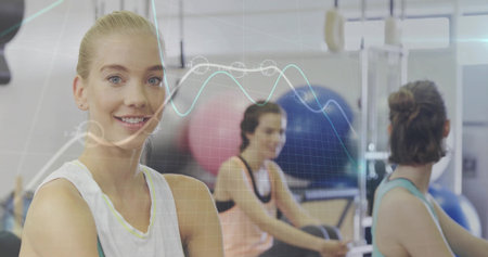 Smiling gym woman crossing arms on left side, with resistance machines and data overlay, copy space....