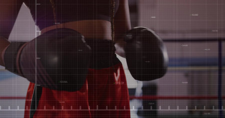 Boxing female athlete analyzing workout metrics inside gym boxing ring, with gloves and ring ropes....