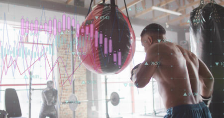 Punching shirtless male athlete delivering strike to red punching bag at gym, with data overlays....