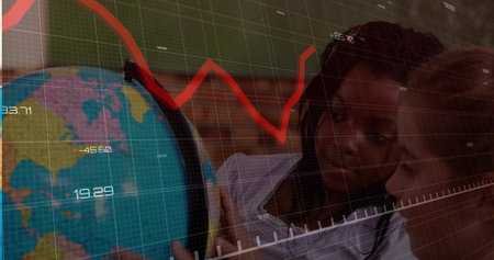 Schoolgirls leaning and pointing at terrestrial globe in classroom, with data overlay and red chart. Education, collaboration, visualization, innovation, stem, young learners, intellectual curiosityの写真素材