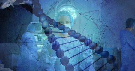 Monitoring surgeon in blue scrubs examining DNA helix in surgical suite, with computer console. Medical, innovation, biotechnology, digital, precision, collaboration, futuristicの写真素材