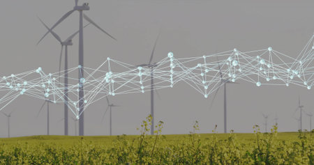 Rotating modern wind turbine tower rising over yellow crop field, with glowing network overlay. Renewable, sustainability, technology, environment, futuristic, energy, eco-friendlyの写真素材