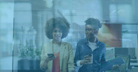 Walking colleagues carrying smartphone, coffee cup, blue folder in office hall, with digital charts. Business, teamwork, innovation, technology, contemporary, collaboration, productivityの写真素材