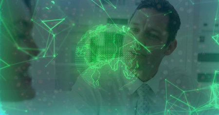 Studying colleagues in suits viewing holographic globe with network nodes and triangles in office....