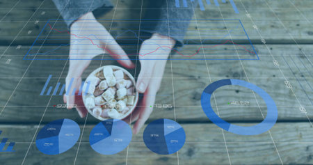 Hands in sweater holding bowl of marshmallows and chocolate on wooden table. Cooking, confectionery, dessert, rustic, comfortの写真素材