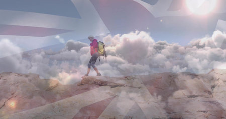 Lone female hiker crossing rocky ridge, with large hiking backpack and hiking boots, copy space. Adventure, exploration, mountain, outdoor, trek, elevation, activewearの写真素材