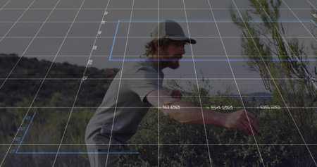 Extending man wearing baseball cap and tee reaching toward right in scrubland with digital grid. Adventure, exploration, technology, futurism, outdoor, landscape, measurementの写真素材