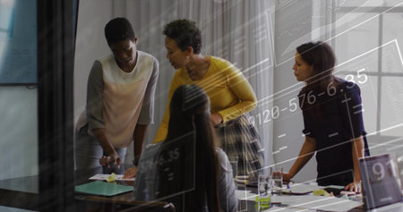 Collaborating four business women analyzing financial charts in office meeting room, with documents....