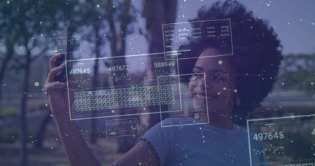 Interacting woman holding smartphone viewing data panels on park path beside railing, copy space. Futuristic, augmented reality, technology, outdoor, park, data visualization, digital interfaceの写真素材