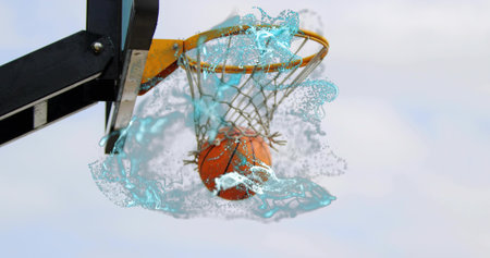 Falling orange basketball passing through net at outdoor hoop, swirling water-like splash effect....