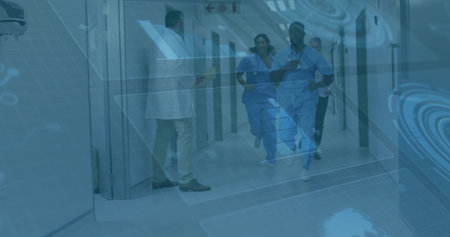 Running mid adult African American nurse moving down hospital corridor, with stethoscope and badge....