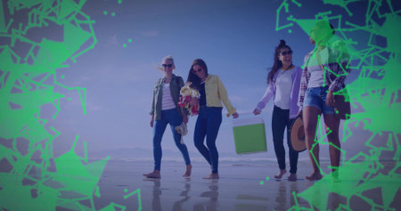 Walking group of four women on beach at low tide, carrying green cooler, bouquet and flip-flops. Friends, leisure, outdoors, summer, lifestyle, reflection, vibrantの写真素材