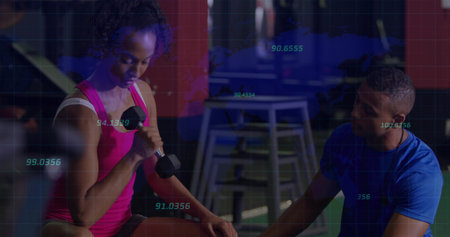 Client curling dumbbell on gym bench with kneeling trainer, plyo boxes, metrics overlay, copy space....