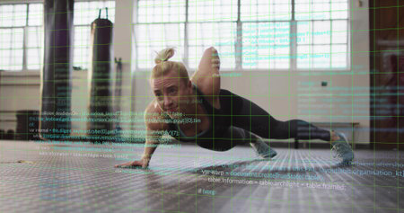 Trainer performing one-armed push-up variation in gym, with hex mat, heavy bag and code overlay....