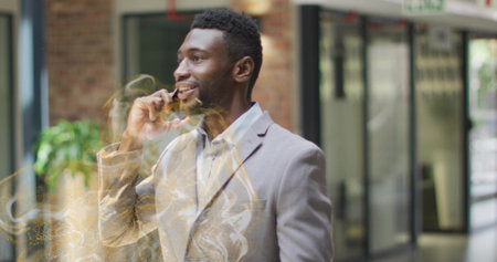 Smiling business professional in suit holding smartphone in office lobby. Corporate, communication, futuristic, professional, networking, productivity, innovationの写真素材
