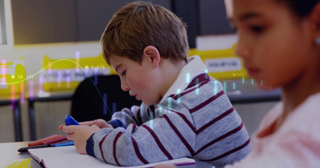 Focusing boy interacting with smartphone in classroom with notebook, pencil case and chart overlay....
