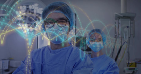 Monitoring vitals masked surgeons watching waveform in operating room, with surgical lamp, monitors. Medical, healthcare, precision, technology, teamwork, clinical, innovationの写真素材