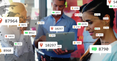 Scrolling female professional holding tablet at office space, with map overlay, laptop, copy space. Collaboration, technology, innovation, digital, connectivity, teamwork, modernの写真素材