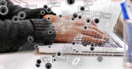 Typing hands in gray sweater on silver laptop at white desk with digital interface overlays....