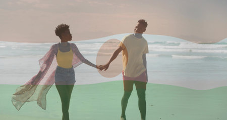 Walking couple holding hands along shoreline near ocean, with sunglasses and pink duster fluttering....