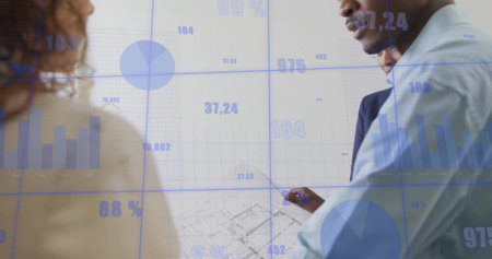 Man wearing dress shirt pointing at floor plan in office with translucent charts, copy space. Corporate, infographic, modern, analytics, presentation, collaboration, data visualizationの写真素材