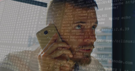 Talking on gold phone, engineer in checkered shirt gazing out office window, with network overlay....