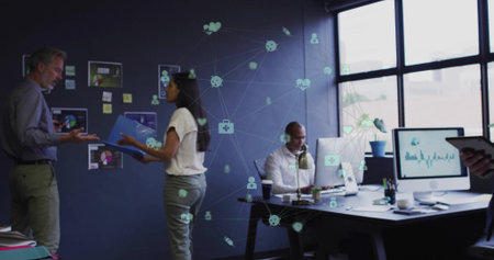 Gesturing team exchanging data at office meeting, with blue folder, charts, devices, network icons. Collaboration, teamwork, digital connectivity, data analysis, modern workspace, business communication, innovationの写真素材