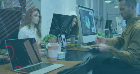 Tapping touchscreen while holding smartphone, bearded man working in office with charts, copy space. Collaboration, technology, workspace, modern, productivity, digital, teamworkの写真素材