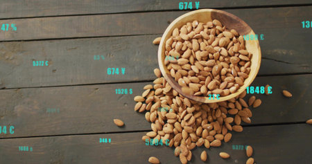 Showing wooden bowl spilling almonds on wooden tabletop, floating turquoise annotations. Snacking, rustic, organic, overlay, casualの写真素材