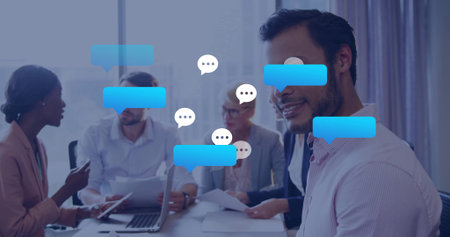 Smiling man in button-down shirt engaging office meeting, with laptop and papers, copy space. Collaboration, teamwork, professional, communication, business, modern, corporateの写真素材