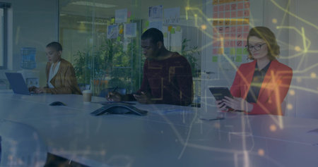 Three business professionals collaborating in glass meeting room, digital devices and sticky notes....