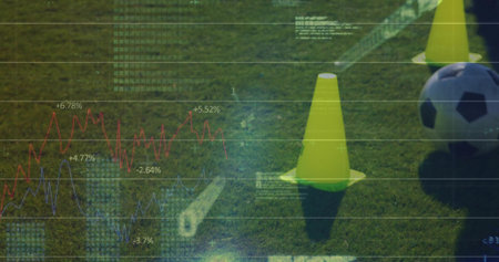 Showing yellow training cones and soccer ball resting on grass turf, with data overlay, copy space. Sports, analytics, technology, training, data visualization, performance, outdoorsの写真素材