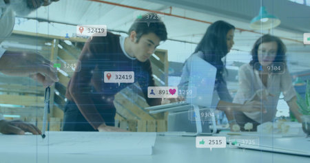 Gesturing professionals examining plans with tablet in open-plan office, with floating icons....
