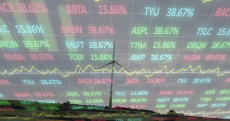 Displaying wind turbine standing under clouds, yellow line graph and ticker symbols over grid lines....