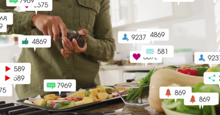 Sprinkling woman seasoning vegetables on kitchen counter with pepper grinder and social media icons. Cooking, culinary, food prep, healthy eating, rustic, vibrant, social mediaの写真素材