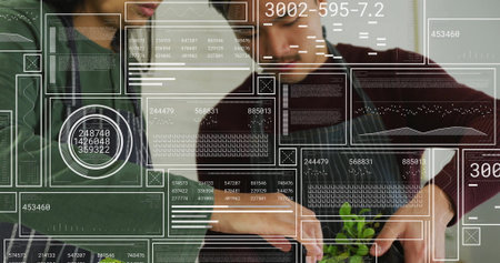 Home cooks wearing aprons tearing fresh greens into bowl in kitchen, with overlay panels. Culinary, innovation, smart kitchen, collaboration, health, technology, modern designの写真素材