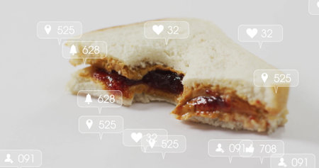 Displaying half-eaten white bread peanut butter and jelly sandwich on surface with notifications. Snack, digital, engagement, social media, consumption, modern, minimalistの写真素材