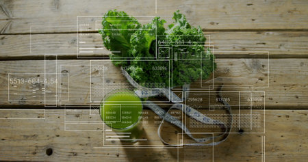 Showing kitchen counter featuring curly kale on tray, with bowl, juice glass, apple, measuring tape.の写真素材