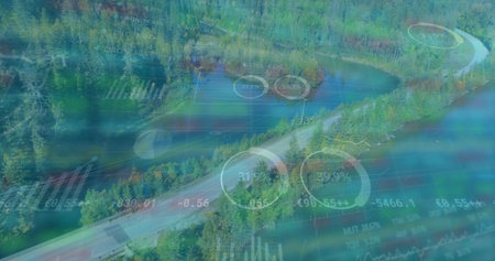 Displaying winding paved road through evergreen forest beside lake, with digital data overlays....