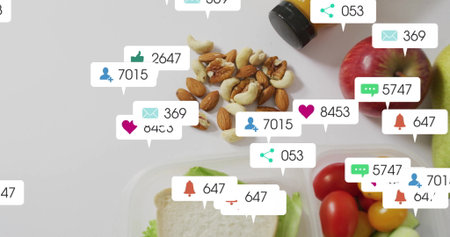 Flat lay showing healthy food items, amber bottle on counter, with social media notification icons. Nutrition, wellness, fresh produce, digital marketing, health campaign, vibrant, lifestyleの写真素材