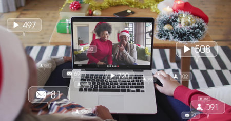 Viewing holiday chat on laptop screen in living room, with gifts, chat bubbles and Santa hats....